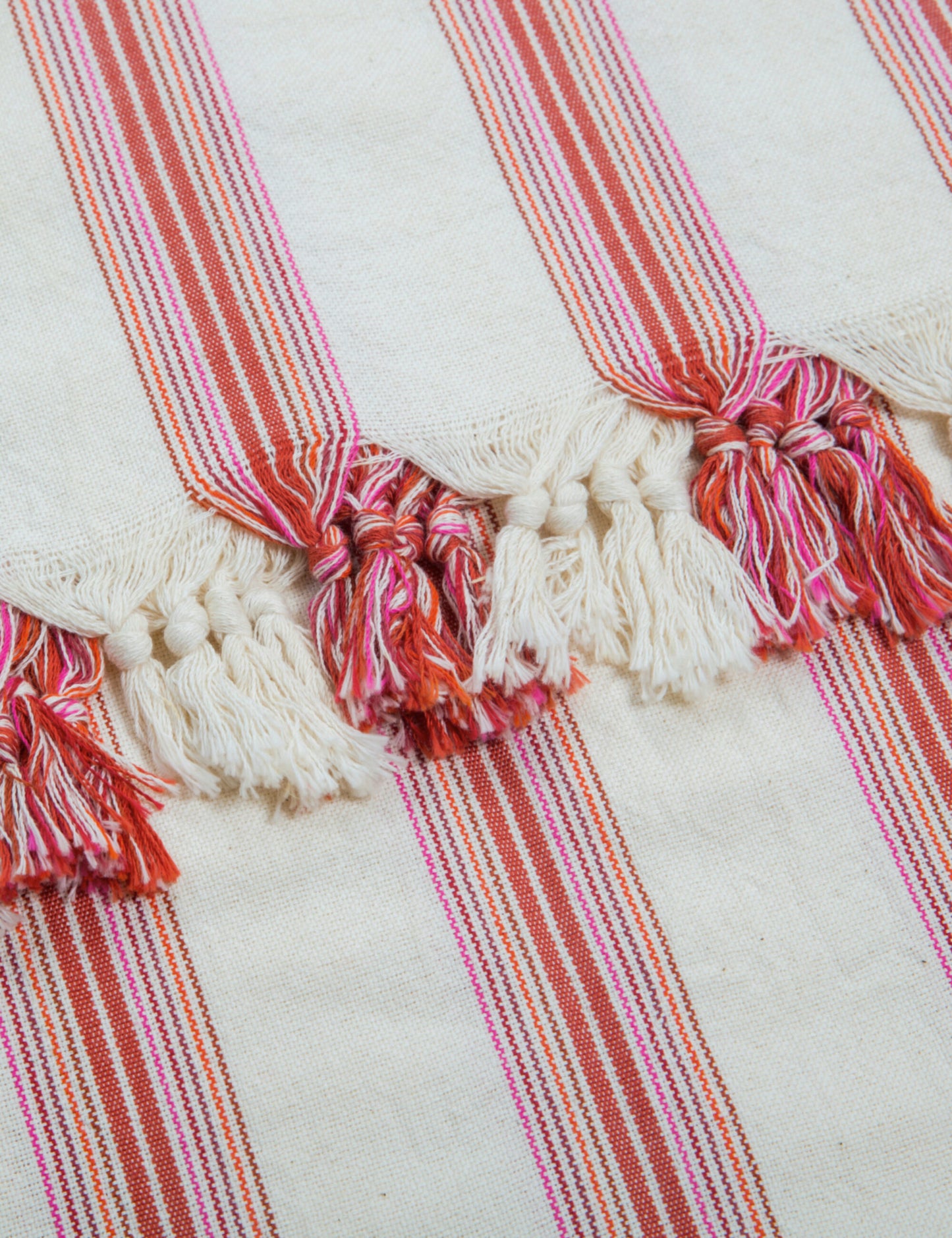 Ruby handwoven hammam towel with red and orange stripes, crafted by artisans. Perfect as a peshtemal, cotton beach, or sauna towel.