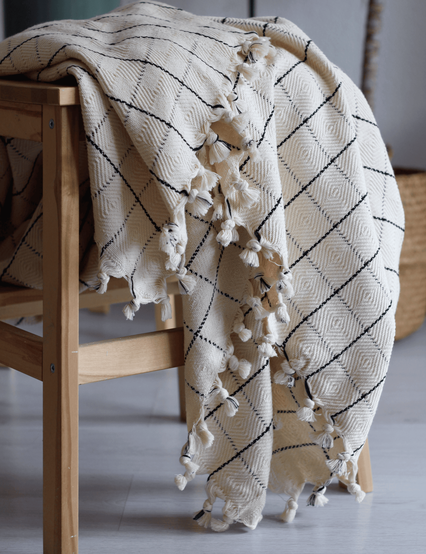 Luxurious handwoven cotton throw blanket with classic windowpane pattern, enhancing home decor with its timeless design.