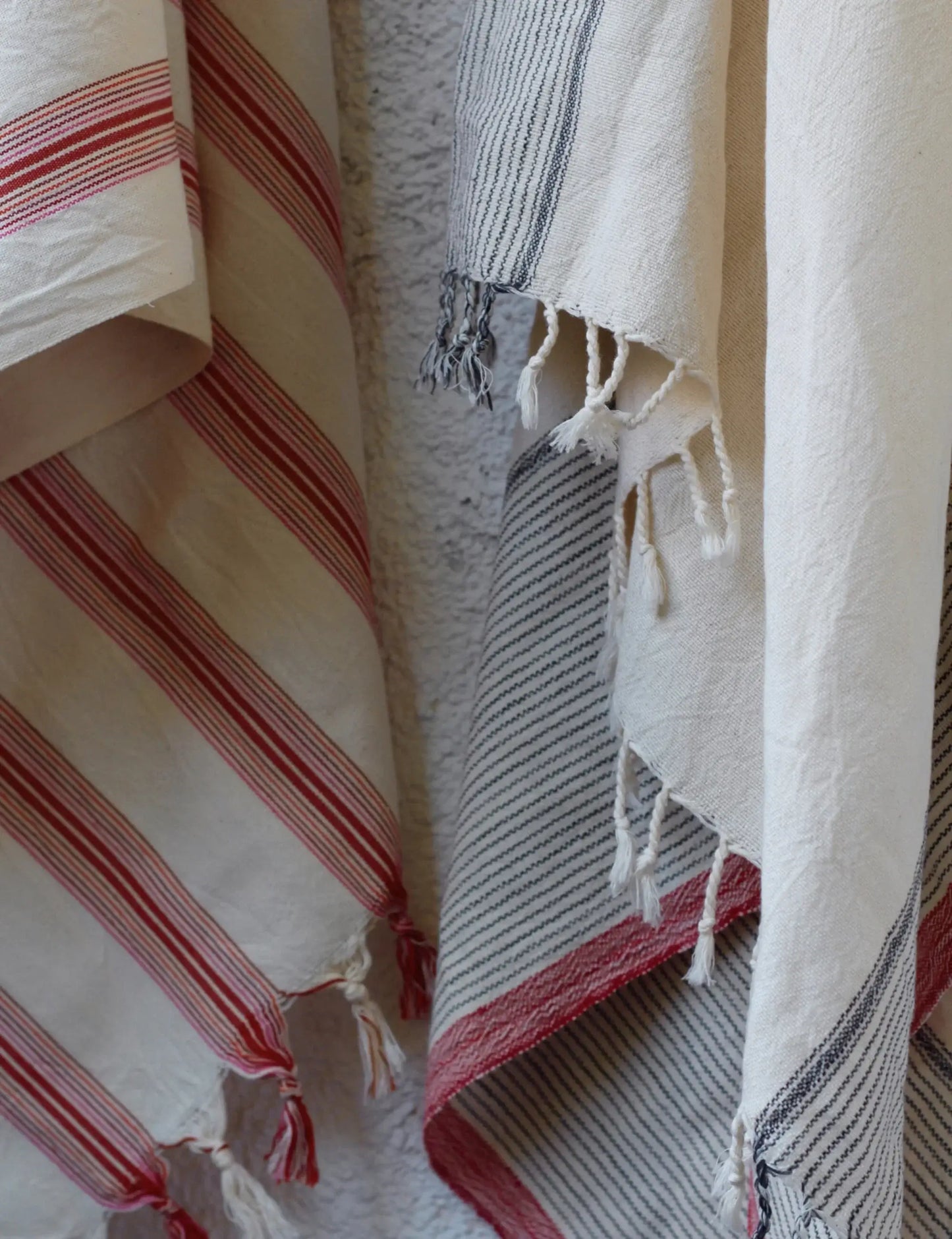 Handwoven hammam towels with red stripes, showcasing artisanal craftsmanship and cotton blend. Perfect as peshtemal or beach towel.